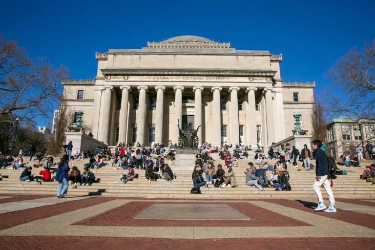 Students sit on the front steps of Low Memorial Library on the Columbia University campus in New York City, Feb. 10, 2023.