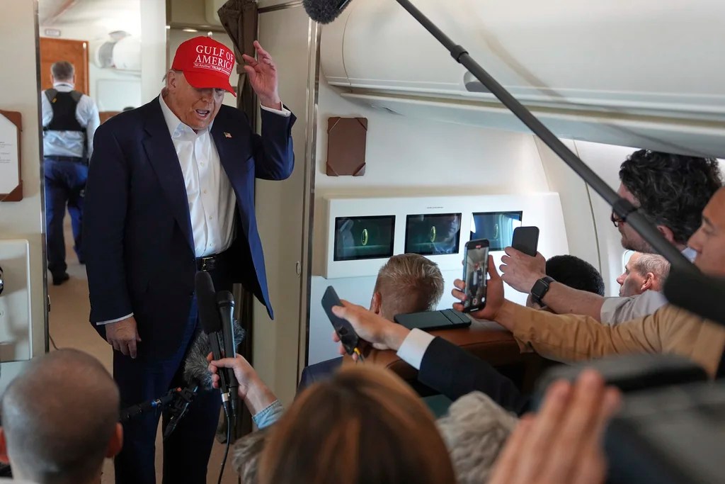 President Donald Trump talks with reporters on Air Force One after visiting a migrant detention center in Ochopee, Fla., Tuesday, July 1, 2025, as he heads back to Joint Base Andrew, Md. 