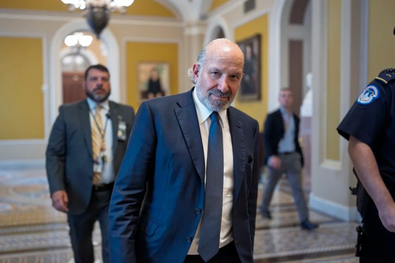 Commerce Secretary Howard Lutnick walks through a corridor at the Senate.