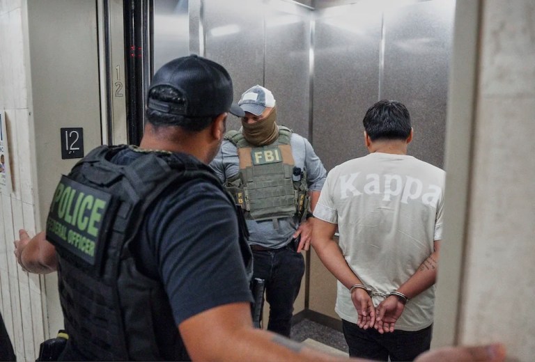 Immigration and Customs Enforcement officers escort a detained immigrant into an elevator after he exited an immigration courtroom, Tuesday, June 17, 2025, in New York.