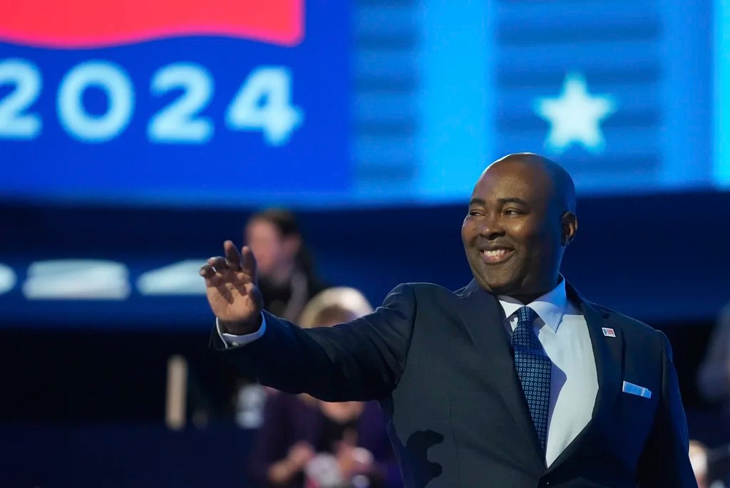 Jaime Harrison, chair of the Democratic National Committee, waves during the Democratic National Convention Monday, Aug. 19, 2024, in Chicago.