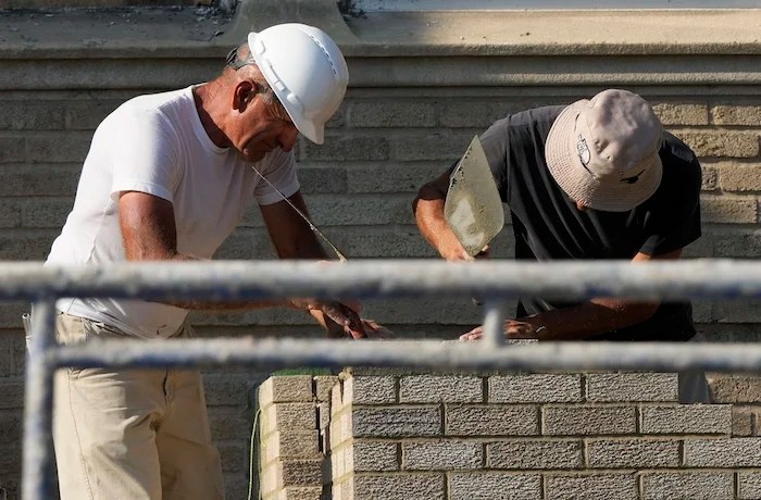 Construction workers work at a residential building site in Chicago