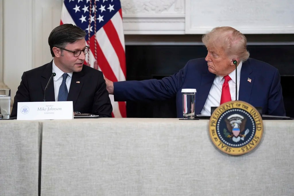 President Donald Trump listens as House Speaker Mike Johnson, R-La., speaks during an "Invest in America" roundtable with business leaders at the White House, Monday, June 9, 2025, in Washington.