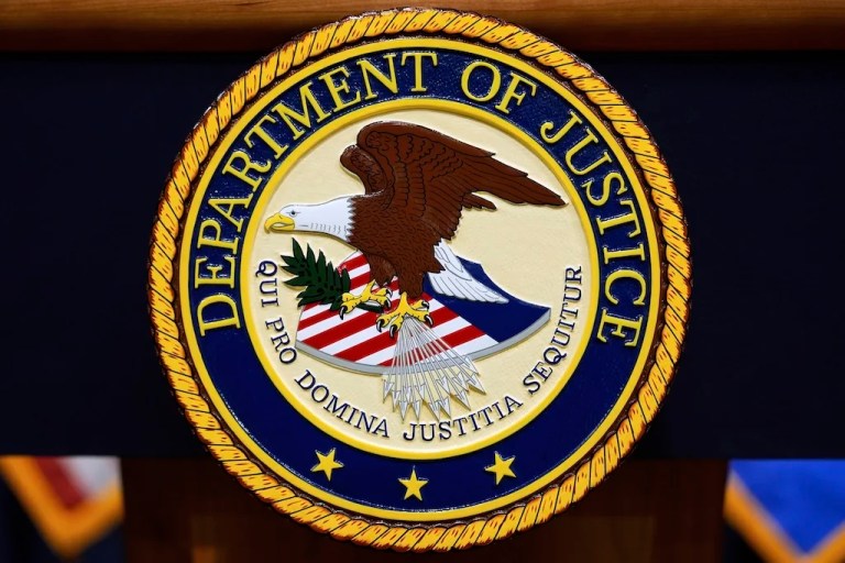 FILE - The U.S. Department of Justice logo is seen on a podium before a press conference, May 6, 2025, at the Justice Department in Washington. (AP Photo/Julia Demaree Nikhinson, File)