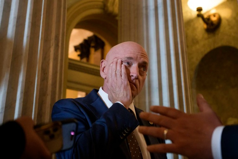 Sen. Mark Kelly (D-AZ) talks with reporters outside the Senate chamber as Senate Republicans vote on President Donald Trump's request to cancel about $9 billion in foreign aid and public broadcasting spending, at the Capitol in Washington, Wednesday, July 16, 2025.