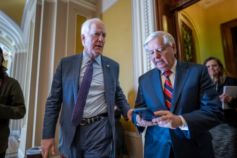 Sen. John Cornyn (R-TX), left, talks with Sen. Lindsey Graham (R-SC) outside the chamber during a test vote to begin debate on a border security bill, at the Capitol in Washington, Wednesday, Feb. 7, 2024.