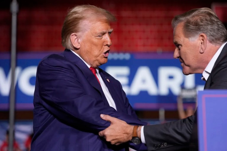Republican presidential nominee former President Donald Trump shakes hands with Senate candidate former Rep. Mike Rogers, speaks at a campaign event at the Ryder Center at Saginaw Valley State University, Thursday, Oct. 3, 2024, in University Center, Mich.