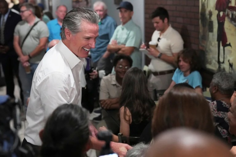 Gov. Gavin Newsom (D-CA) greets people in a coffee shop during a two-day swing through South Carolina on Tuesday, July 8, 2025, in Florence.