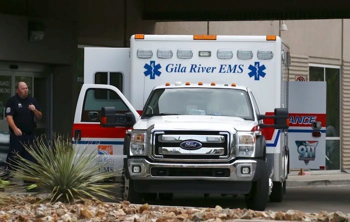 An ambulance parks at the emergency room entrance at Banner Estrella Medical Center July 19, 2020, in Phoenix. Officials say Phoenix-based Banner Health is at its most overwhelmed level since the pandemic began. That has led executives to issue a bleak warning that the hospital system may have to eventually choose who can receive care.