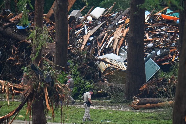 Officials comb through the banks of the Guadalupe River after a flash flood swept through the area Saturday, July 5, 2025, in Hunt, Texas.
