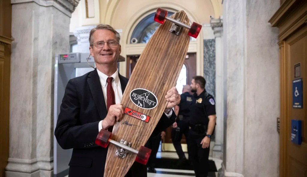 Rep. Tim Burchett (R-Tenn.) holds a skateboard with his name on it at the U.S. Capitol July 15, 2025.