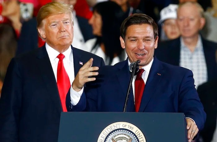President Donald Trump stands behind Ron DeSantis, Candidate for Governor of Florida, as he speaks at a rally, Saturday, Nov. 3, 2018, in Pensacola, Fla. (AP Photo/Butch Dill)