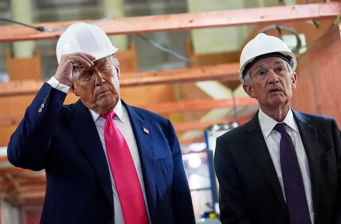 President Donald Trump listens as Federal Reserve Chairman Jerome Powell speaks during a visit to the Federal Reserve, Thursday, July 24, 2025, in Washington.