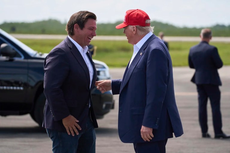 President Donald Trump is greeted by Gov. Ron DeSantis (R-FL) after arriving at Dade-Collier Training and Transition Airport, Tuesday, July 1, 2025, in Ochopee, Florida.