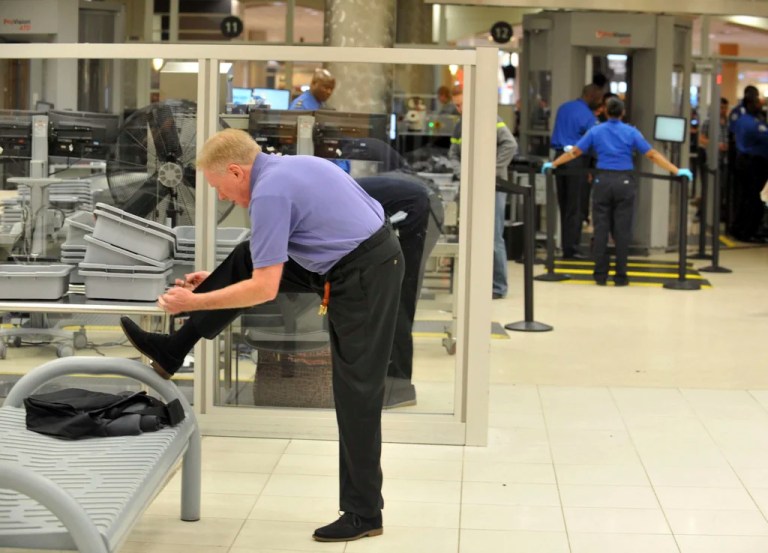 A traveler removes his shoes at Hartsfield-Jackson Atlanta International Airport on Wednesday, Jan. 15, 2014.