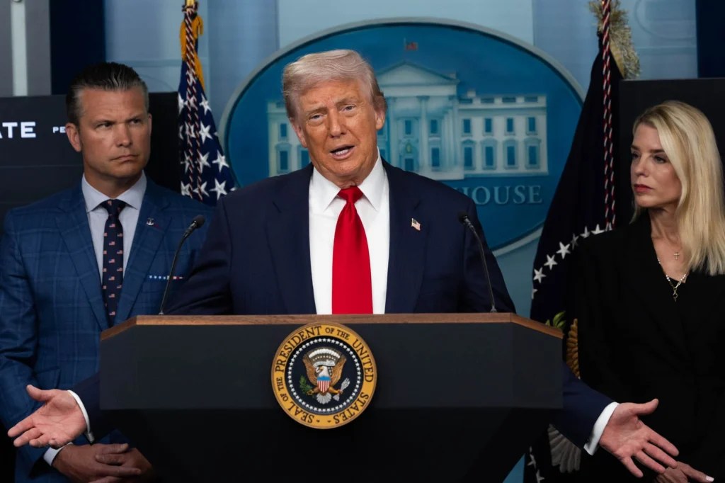 President Donald Trump stands at the lectern in the White House briefing room.
