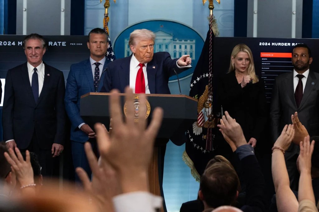 President Donald Trump speaks in the White House press briefing room on Aug. 11, 2025 about the federal takeover of Washington DC police. Defense Secretary Pete Hegseth and Attorney General Pam Bondi are beside him. (Graeme Jennings/Washington Examiner)