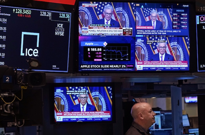 Television screens on the floor of the New York Stock Exchange show the news conference of Federal Reserve Chair Jerome Powell, Wednesday, Jan. 31, 2024. A strong performance in financial markets, particularly an outsize gain for the stock market in 2021, helped entrench existing trends of wealth inequality during the pandemic.