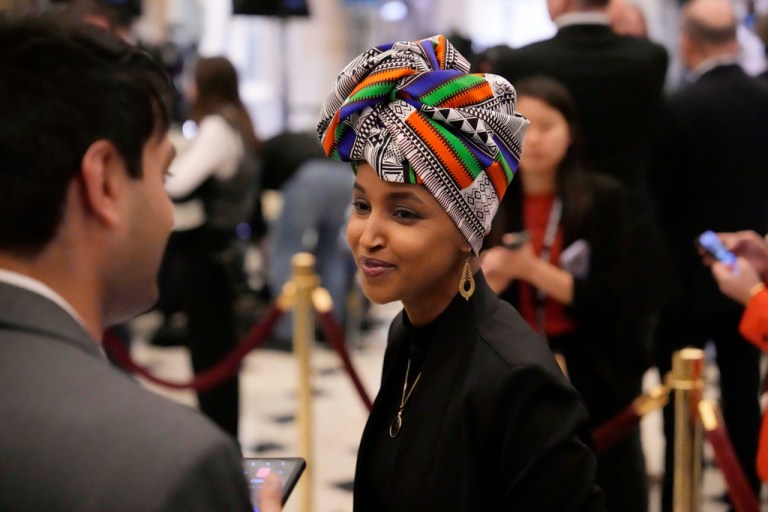 Ilhan Omar, D-Minn., smiles at a reporter before President Donald Trump arrives to address a joint session of Congress