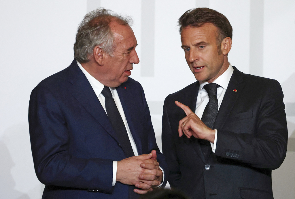 French President Emmanuel Macron, right, speaks with French Prime Minister François Bayrou during a collective awards ceremony in honor of those who contributed to the restoration of Notre-Dame Cathedral at the Elysee Palace in Paris, Tuesday, April 15, 2025. 