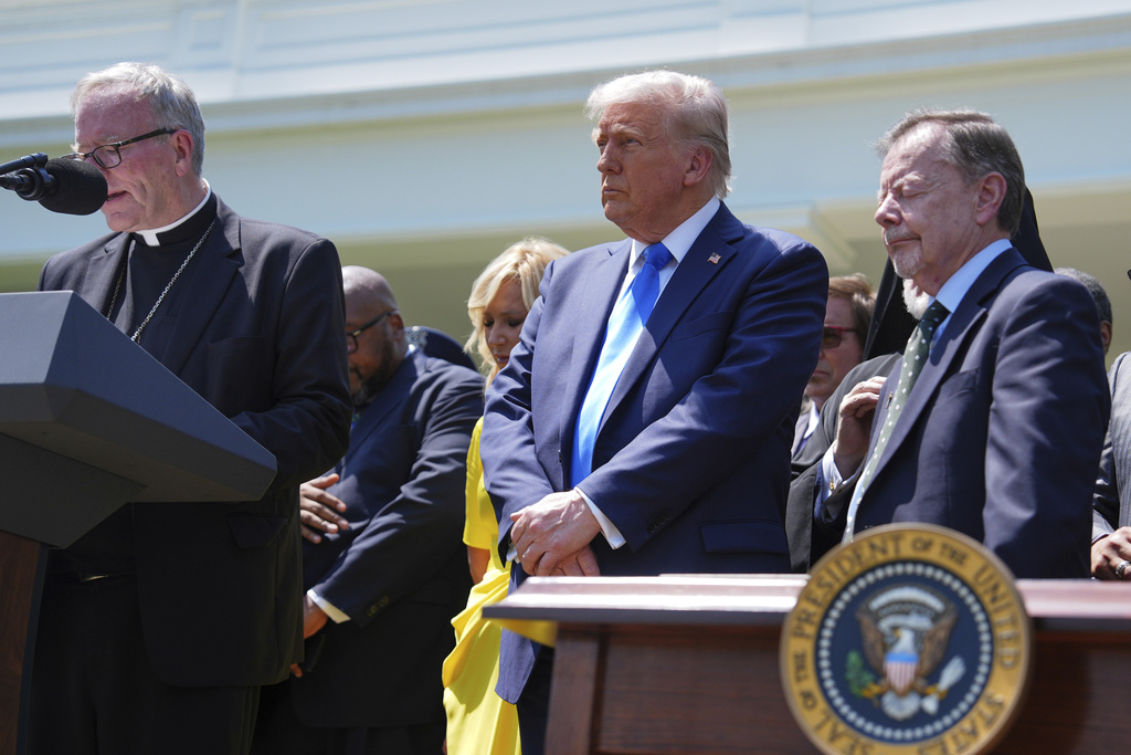 Bishop Robert Barron speaks as President Donald Trump, center, listens during a National Day of Prayer event in the Rose Garden of the White House, Thursday, May 1, 2025, in Washington.