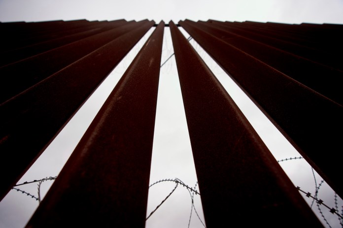 Concertina lines the interior of a border wall, one of two separating Tijuana, Mexico, from the United States, Wednesday, June 4, 2025, in San Diego. (AP Photo/Gregory Bull)