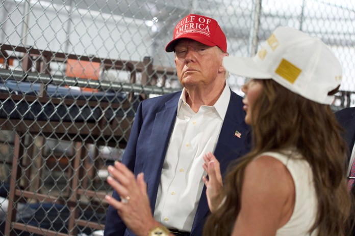 President Donald Trump listens as Homeland Security Secretary Kristi Noem speaks during a tour of "Alligator Alcatraz," a new migrant detention facility at Dade-Collier Training and Transition facility on Tuesday, July 1, 2025, in Ochopee, Florida.