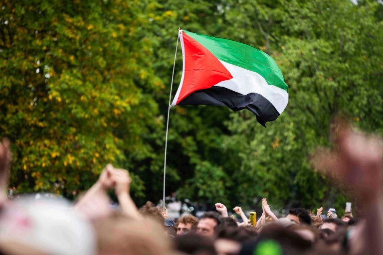 The Palestinian flag waving in a crowd.