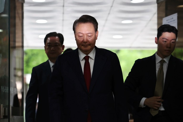 Former South Korean President Yoon Suk Yeol, center, arrives at a court to attend a hearing to review his arrest warrant requested by special prosecutors in Seoul, South Korea Wednesday, July 9, 2025.