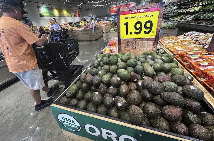 Avocados are displayed as customers shop at a grocery store in Glenview, Ill., Tuesday, July 15, 2025.