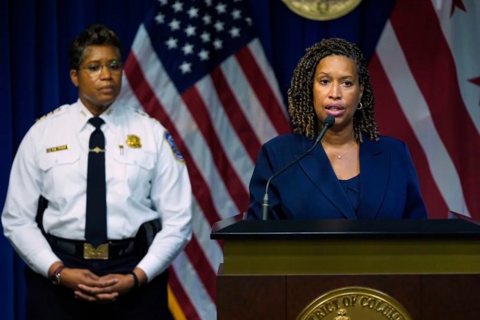 D.C. Mayor Muriel Bowser speaks as Metropolitan Police Department Chief Pamela Smith listens during a news conference on President Donald Trump's plan to place Washington police under federal control and deploy National guard troops to Washington, Monday, Aug. 11, 2025, in Washington.