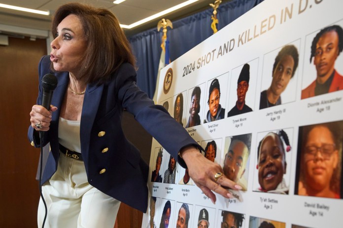 U.S. Attorney for the District of Columbia Jeanine Pirro points to a photo of 3-year-old Ty'ah Settles as she describes murder victims in Washington in 2024, Tuesday, Aug. 12, 2025, during a news conference at the U.S. Attorney's office in Washington. (AP Photo/Jacquelyn Martin)
