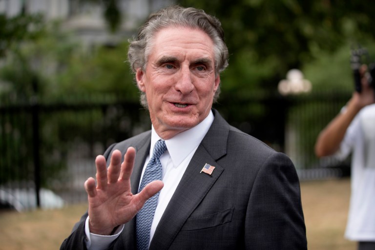 Interior Secretary Doug Burgum walks after giving a television interview outside the White House, Tuesday, Aug. 12, 2025, in Washington.