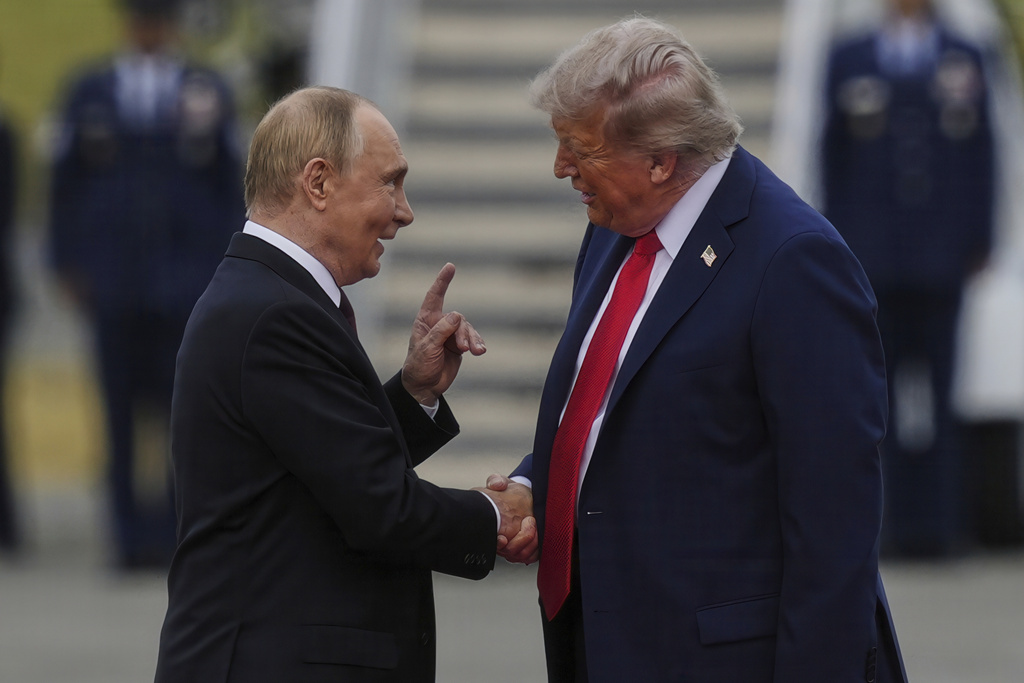 President Donald Trump greets Russian President Vladimir Putin on Friday, Aug. 15, 2025, at Joint Base Elmendorf-Richardson, Alaska.