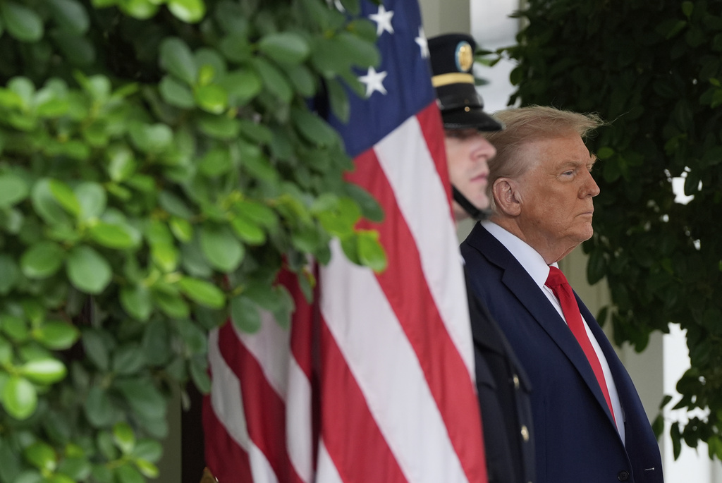 President Donald Trump waits to greet Ukrainian President Volodymyr Zelensky at the White House, Monday, Aug. 18, 2025, in Washington.