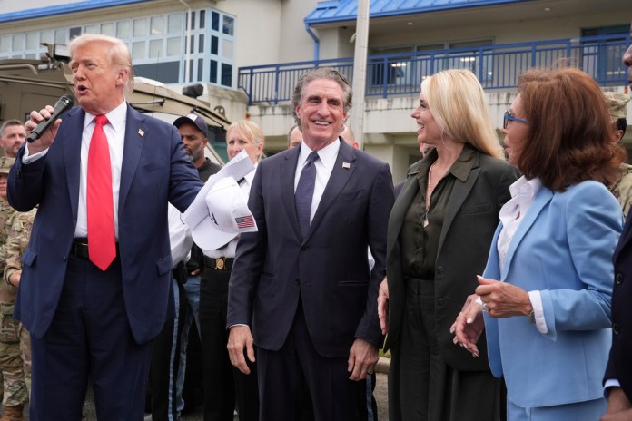 President Donald Trump speaks with members of law enforcement and National Guard soldiers, Thursday, Aug. 21, 2025, in Washington, as Interior Secretary Doug Burgum, Attorney General Pam Bondi, and U.S. Attorney for the District of Columbia Jeanine Pirro listen.