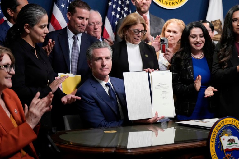 Gov. Gavin Newsom (D-CA) signs legislation.