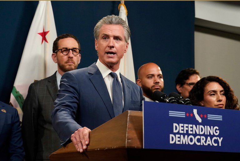 Gov. Gavin Newsom addresses reporters after signing a package of measures to redraw the state's Congressional districts and put new maps before voters in a special election, in Sacramento, Calif.,Thursday, Aug. 21, 2025. (AP Photo/Rich Pedroncelli)