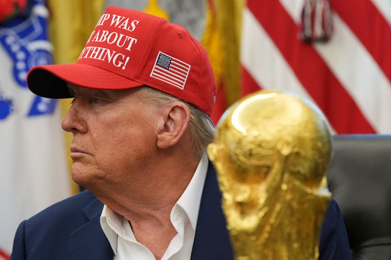 President Donald Trump is pictured alongside the FIFA World Cup Winners Trophy during an announcement event in the Oval Office of the White House, Friday, Aug. 22, 2025, in Washington.