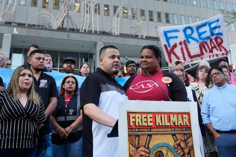 Jennifer Vasquez Sura, front left, and her husband Kilmar Abrego Garcia, front center, attend a protest rally at the Immigration and Customs Enforcement field office in Baltimore, Monday, Aug. 25, 2025, to support Kilmar Abrego Garcia. (AP Photo/Stephanie Scarbrough)