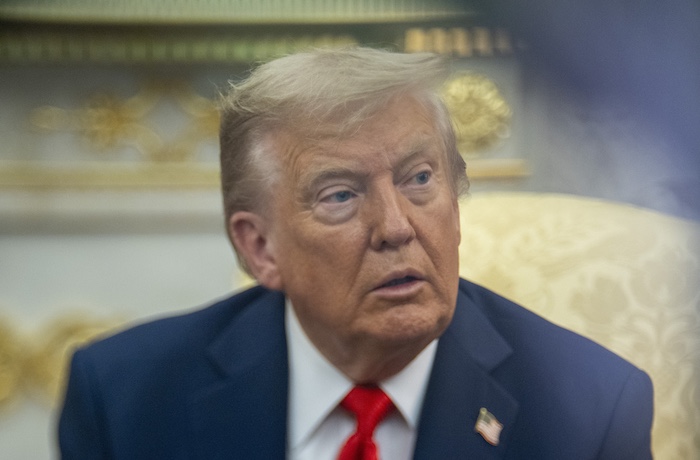 President Donald Trump listens as he meets with South Korean President Lee Jae Myung in the Oval Office of the White House.