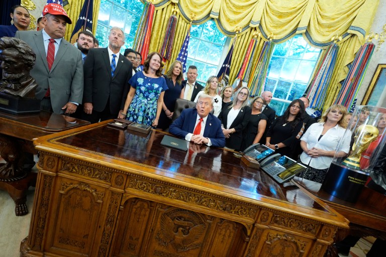 President Donald Trump, surrounded by family members of soldiers killed in Afghanistan at the attack at Abbey Gate, speaks during an event for the signing of a proclamation honoring the fourth anniversary of the attack, in the Oval Office of the White House, Monday, Aug. 25, 2025, in Washington.