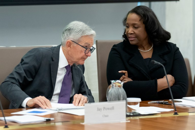 Federal Reserve Chairman Jerome Powell, left, talks with Board of Governors member Lisa Cook, right, during an open meeting of the Board of Governors at the Fed, June 25, 2025, in Washington.