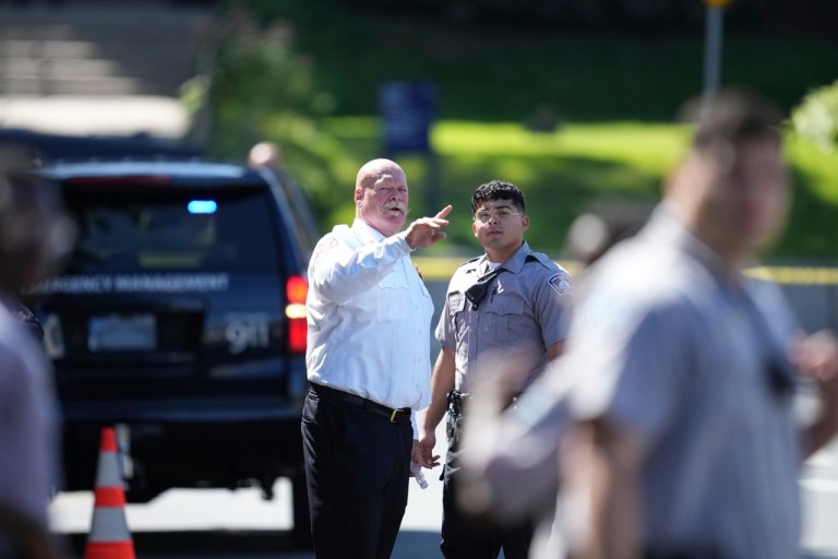 Law enforcement officers gather outside the Annunciation Church's school in response to a reported mass shooting.