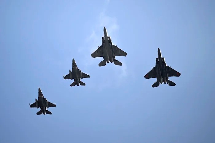 A U.S. Air Force F-15EX Eagle II, F-15E Strike Eagle, and two F-16 Fighting Falcon fighter jets from Eglin Air Force Base perform a flyover during the national anthem before an NCAA college football game between Florida and Georgia, Saturday, Nov. 2, 2024, in Jacksonville, Florida.