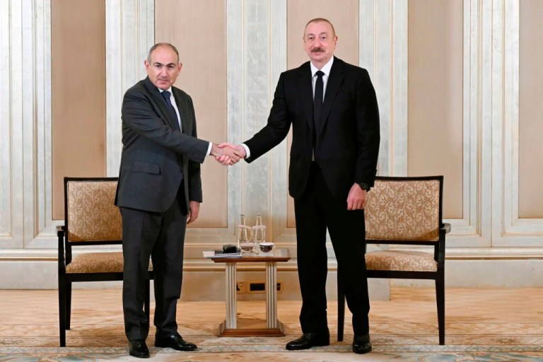 In this photo provided by the Azerbaijan's Presidential Press Office on Thursday, July 10, 2025, Azerbaijani President Ilham Aliyev, right, and Prime Minister of Armenia Nikol Pashinyan pose for a photo prior to their talks in Abu Dhabi, United Arab Emirates.