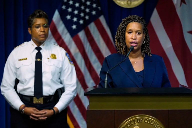 Washington Mayor Muriel Bowser speaks as Metropolitan Police Department Chief Pamela Smith listens during a news conference on President Donald Trump's plan to place Washington police under federal control and deploy National guard troops to Washington.