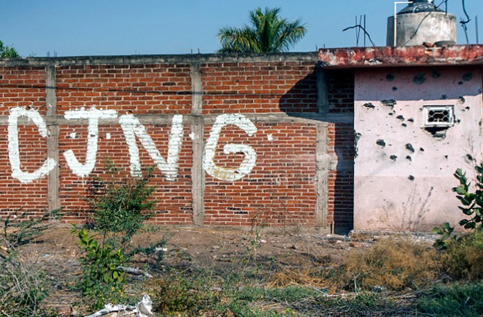 A bullet-riddled wall bearing the initials of the Cartel Jalisco Nueva Generacion (CJNG) in Michoacan, Mexico, April 23, 2021.(Enrique Castro/AFP/Getty)