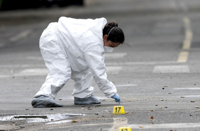 A criminologists catalogs evidence in Mexico City where the city’s chief of police was shot and two of his bodyguards were killed, June 26, 2020. The attack was blamed on the Cartel Jalisco Nueva Generacion (CJNG). (Leonardo Casas Eyepix/abacapress.com/Newscom)