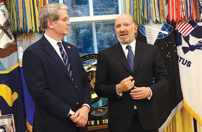 Treasury Secretary Scott Bessent (left) speaks with Secretary of Commerce Howard Lutnick in the White House on Aug. 6. (Win McNamee/Getty Images)